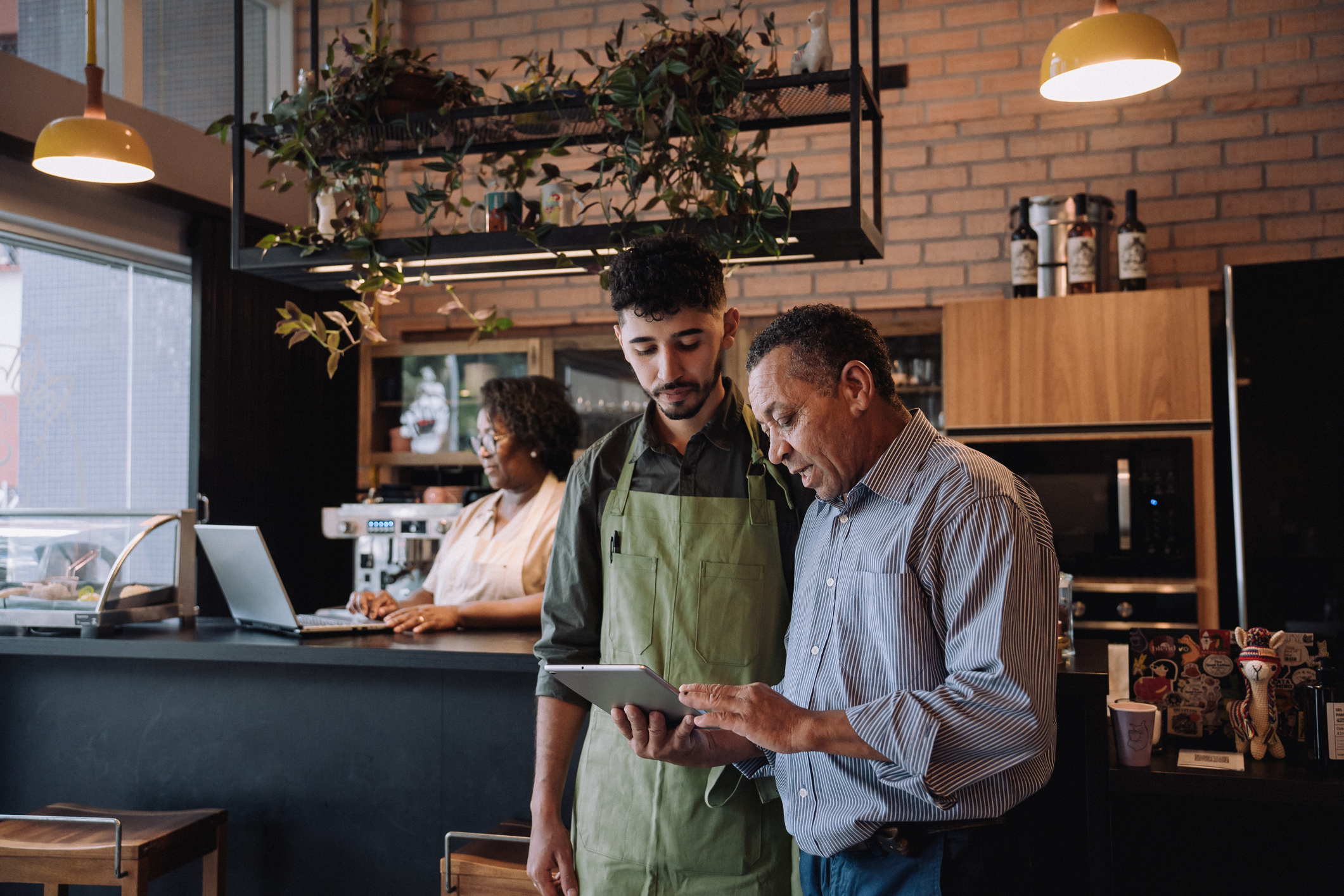 Coffee shop owner talking to employee